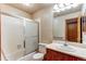 Bathroom with a vanity sink, toilet, and shower-tub with a glass door at 2690 E Otero Pl # 7, Centennial, CO 80122