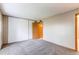 Bedroom featuring closet and access to other rooms with carpeted floor and natural light at 2690 E Otero Pl # 7, Centennial, CO 80122