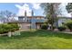 Inviting townhome showcasing a lush green lawn, mature trees, and a charming architectural design at 2690 E Otero Pl # 7, Centennial, CO 80122