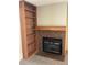 Close-up of the fireplace featuring brick surround, a wood mantle, and built-in shelves on the side at 2690 E Otero Pl # 7, Centennial, CO 80122