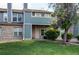 Charming townhome with a well-manicured lawn, brick accents, and a covered front porch at 2690 E Otero Pl # 7, Centennial, CO 80122