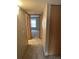 Hallway featuring neutral walls, carpet, a closet, and a view into a bright room with a window at 2690 E Otero Pl # 7, Centennial, CO 80122
