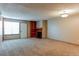 Spacious living room with neutral carpet, fireplace, and built-in shelving at 2690 E Otero Pl # 7, Centennial, CO 80122
