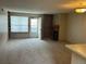 Bright living room featuring neutral carpet, a fireplace, built-in shelves, and a sliding door to the balcony at 2690 E Otero Pl # 7, Centennial, CO 80122