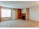 Cozy living room featuring neutral carpet, a fireplace, and built-in shelving at 2690 E Otero Pl # 7, Centennial, CO 80122