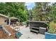 A partially cluttered backyard with a gazebo, hot tub, and various outdoor seating arrangements at 2730 S Jay St, Denver, CO 80227