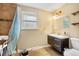 Cozy bathroom with neutral walls, a modern vanity, and a tiled shower stall with a shower chair at 2730 S Jay St, Denver, CO 80227
