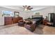 Spacious bedroom features hardwood furniture, fan and a large bed with black sheets and brown leather chairs at 2730 S Jay St, Denver, CO 80227