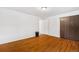 Bright, empty bedroom with hardwood floors and white walls and paneled closet door at 2730 S Jay St, Denver, CO 80227