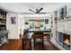 Dining room with a fireplace, wood floors, and a lot of natural light from the window at 2730 S Jay St, Denver, CO 80227
