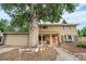 Two-story home with well-kept yard, mature tree, neutral siding, and an attached garage at 2730 S Jay St, Denver, CO 80227