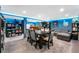 Finished basement game room with a large table, sofa, game shelves, and blue lighting at 2730 S Jay St, Denver, CO 80227