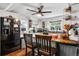 Kitchen island with barstools, white cabinetry, stainless steel appliances, and granite countertops at 2730 S Jay St, Denver, CO 80227