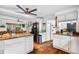 Open concept kitchen boasts granite countertops and stainless steel appliances with wood floors at 2730 S Jay St, Denver, CO 80227