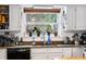 Kitchen sink with a view of the lush greenery outside the window and stainless steel appliances at 2730 S Jay St, Denver, CO 80227