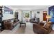 Inviting living room features leather furniture, neutral walls, and a bay window for natural light at 2730 S Jay St, Denver, CO 80227