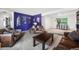 Cozy living room with dark blue accent wall, leather furnishings, and large coffee table at 2730 S Jay St, Denver, CO 80227