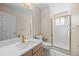 Bright bathroom with white tile, white marble countertop, and gold fixtures at 5946 S Jellison St # F, Littleton, CO 80123