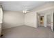 Neutral bedroom with carpet, ceiling fan, and doorway to the bathroom at 5946 S Jellison St # F, Littleton, CO 80123
