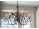 Close up of an ornate chandelier with decorative metalwork and candle-style lights at 5946 S Jellison St # F, Littleton, CO 80123