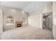 Spacious living area with high ceilings, a cozy fireplace, and a ceiling fan at 5946 S Jellison St # F, Littleton, CO 80123