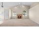 Bright living room with a fireplace and arched windows for natural light at 5946 S Jellison St # F, Littleton, CO 80123
