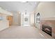 Open-concept living room with a fireplace and arched windows connecting to the kitchen at 5946 S Jellison St # F, Littleton, CO 80123