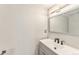 Bathroom featuring gray vanity, white countertop, black fixtures, and ample lighting at 3550 S Harlan St # 105, Denver, CO 80235