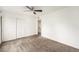 Bright bedroom featuring neutral walls and carpet and a closet with sliding doors at 3550 S Harlan St # 105, Denver, CO 80235
