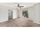 Bedroom showcasing plush carpet, ceiling fan, window and sliding closet door at 3550 S Harlan St # 105, Denver, CO 80235
