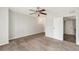 This light bedroom features neutral walls and carpet and a ceiling fan with light at 3550 S Harlan St # 105, Denver, CO 80235