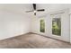 Bedroom showcasing two windows with leafy view, and plush carpeting at 3550 S Harlan St # 105, Denver, CO 80235