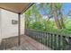 Side view of wooden deck, with a railing, overlooking a green space and sky at 3550 S Harlan St # 105, Denver, CO 80235