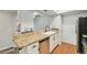 Well-lit kitchen with granite counters, stainless appliances, and white cabinets for a modern aesthetic at 3550 S Harlan St # 105, Denver, CO 80235