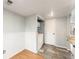 Functional laundry room with washer and dryer, storage cabinets, and a tiled floor at 3550 S Harlan St # 105, Denver, CO 80235
