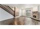 Bright living room with wood flooring, fireplace, stairs and window creating an inviting living space at 3550 S Harlan St # 105, Denver, CO 80235
