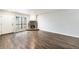 Spacious living room featuring wood floors, a stone fireplace, and a large window for ample natural light at 3550 S Harlan St # 105, Denver, CO 80235