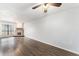 Bright living room featuring beautiful hardwood floors and a cozy stone fireplace at 3550 S Harlan St # 105, Denver, CO 80235