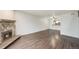 Inviting living room featuring a stone fireplace and dark laminate flooring, perfect for cozy evenings at 3550 S Harlan St # 105, Denver, CO 80235