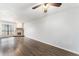 Spacious living room with hardwood floors, a ceiling fan, and a stone fireplace at 3550 S Harlan St # 105, Denver, CO 80235