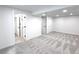 Spacious basement area with neutral carpet, fresh paint and multiple entry and closet doors at 19545 E Bates Ave, Aurora, CO 80013
