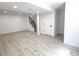 Newly finished basement featuring a staircase and open floorplan at 19545 E Bates Ave, Aurora, CO 80013