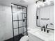 Modern bathroom featuring a glass-enclosed shower, stylish vanity, and black hardware at 19545 E Bates Ave, Aurora, CO 80013