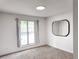 Bright bedroom with a large window, neutral carpet, and minimalist decor at 19545 E Bates Ave, Aurora, CO 80013