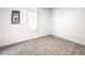 A clean, carpeted bedroom with a light fixture and a window providing natural light at 19545 E Bates Ave, Aurora, CO 80013