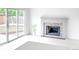 Bright living room with hardwood floors, a brick fireplace, and sliding glass doors to the backyard at 19545 E Bates Ave, Aurora, CO 80013