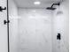 Walk-in shower featuring modern fixtures, glass surround, and newly tiled walls at 19545 E Bates Ave, Aurora, CO 80013