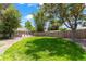 Expansive backyard with a lush lawn, patio area, and privacy fence, perfect for outdoor entertaining and relaxation at 1221 Ulster St, Denver, CO 80220
