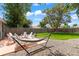 Spacious backyard featuring a seating area, hammock, grass, and a privacy fence at 1221 Ulster St, Denver, CO 80220