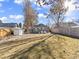 Backyard view featuring a lush lawn, patio with outdoor seating, and detached storage shed at 1221 Ulster St, Denver, CO 80220